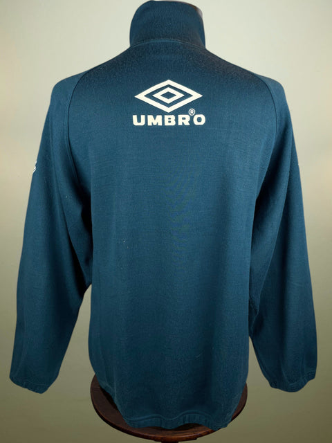 Blue Inter Milan Training Jacket with Umbro logo on a mannequin against a beige background