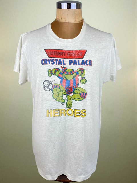 White Crystal Palace t-shirt with a Ninja Turtles graphic design on a mannequin against a plain background