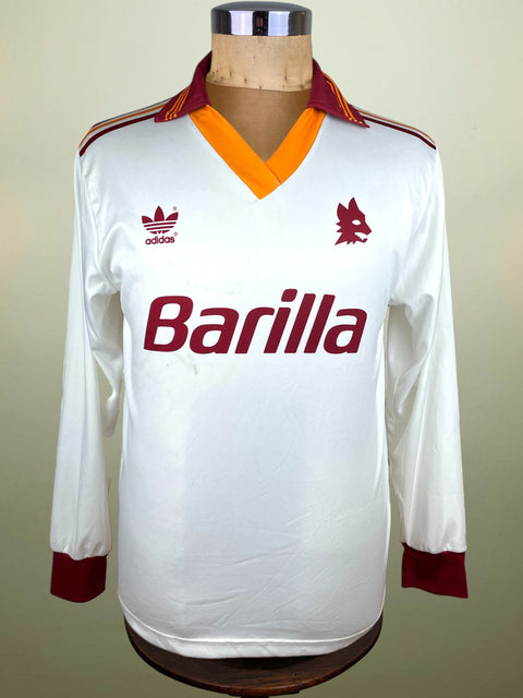 White AS Roma Adidas 1991/92 jersey with red and orange accents on a mannequin against a beige background