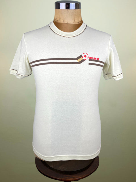 White t-shirt with red and brown Spain 1982 World Cup design on a mannequin against a plain background