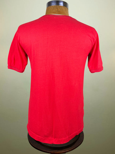 Red t-shirt on a mannequin against a beige background