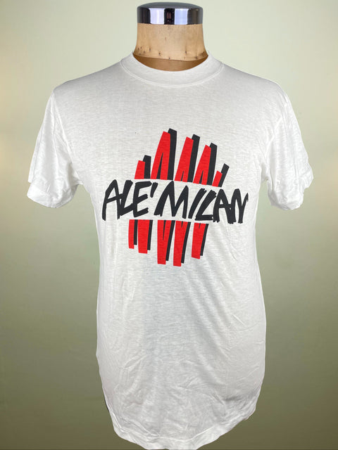 White t-shirt with black and red graphic design on a mannequin against a beige background