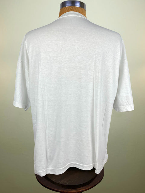 White t-shirt on a mannequin against a beige background