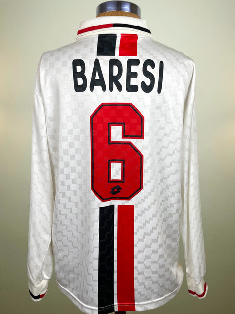 Back view of a white long-sleeve AC Milan Away jersey displayed on a mannequin, featuring the name BARESI in black with a red and black stripe above, and a large red number 6 on the back.