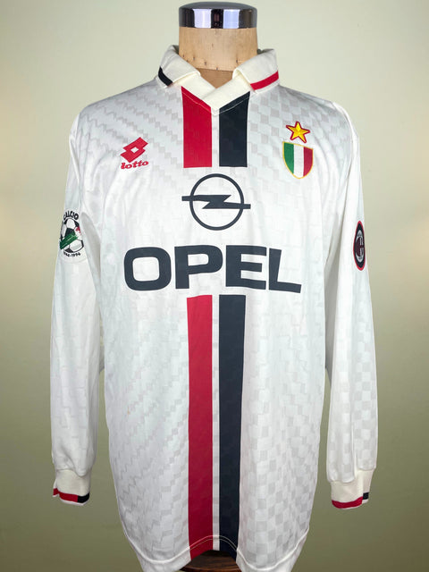 White AC Milan Away jersey made by Lotto with red and black accents, Opel Sponsorship on a mannequin against a neutral background