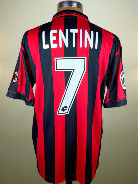 Red and black striped AC Milan 1996-97 jersey with 'LENTINI' and number '7' on a beige background