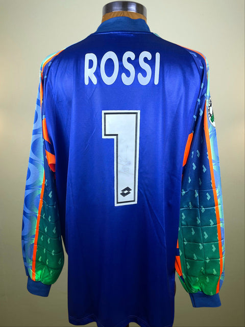 Sabastiano Rossi's Colourful AC Milan 1997-98 Goalkeeper jersey with 'ROSSI' and number '1' and his autograph in the number. On a mannequin against a beige background