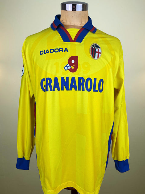 Yellow Bologna Third jersey with Diadora and Granarolo branding on a mannequin against a neutral background