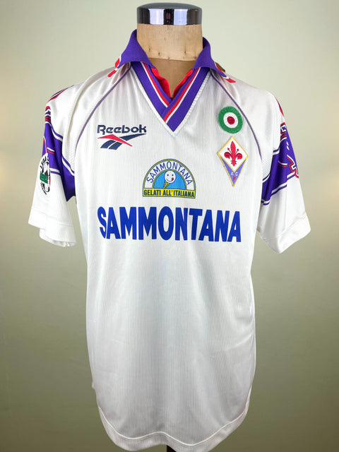 White Fiorentina 1996 Away jersey made by Reebok with Sammontana Sponsor on a mannequin against a plain background
