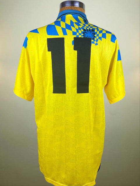 Yellow Inter Milan Third jersey with blue accents and number 11 on a neutral background