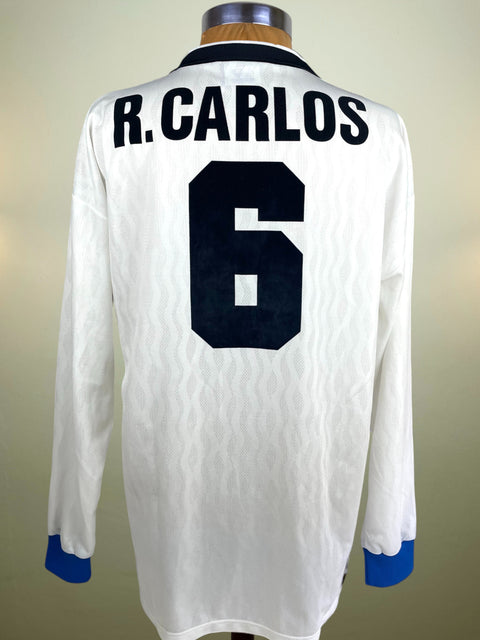 Match Worn 1995-96 Roberto Carlos Away shirt with number 6 and his name in black flock. The shirt is on a mannequin against a plain background.