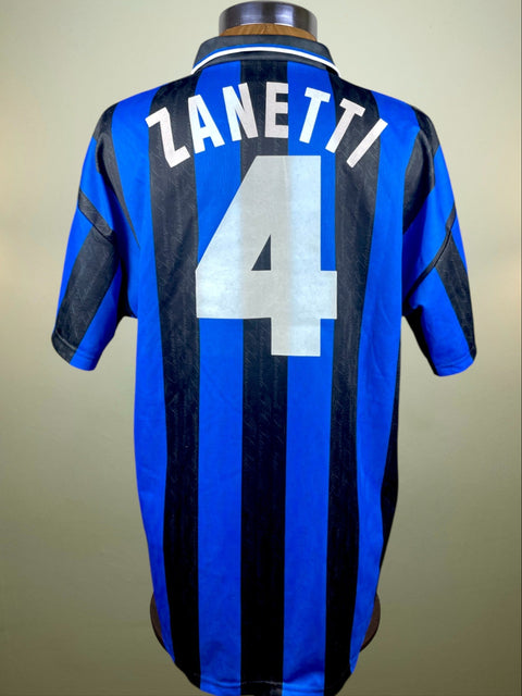 Javier Zanetti's match worn 1996-97 shirt in Blue and black striped with 'Zanetti' and number '4' in flock on a beige background. The shirt has no umbro logo on the number which is consistent with UEFA Cup jerseys.
