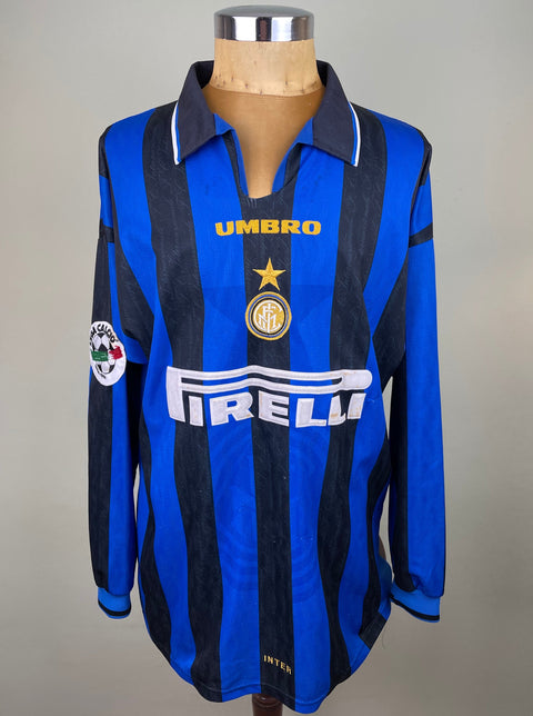 A long-sleeved 1996-97 match worn UEFA cup Inter Milan soccer jersey with a blue body and black accents, featuring the Pirelli sponsor in flock on the chest, and collar cut.