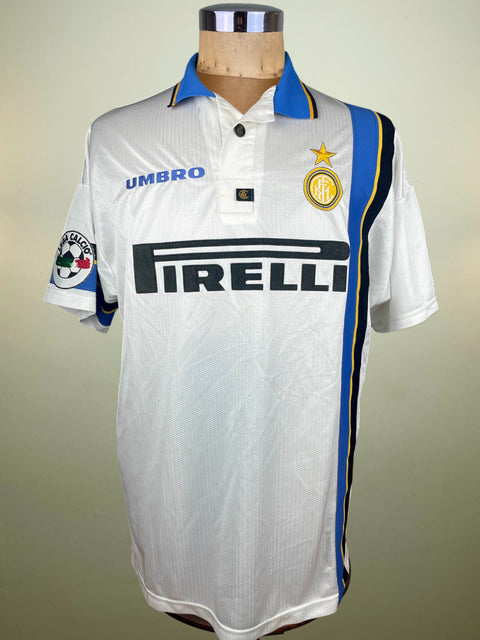 White Inter Milan 1997 jersey with blue and black accents on a mannequin against a neutral background
