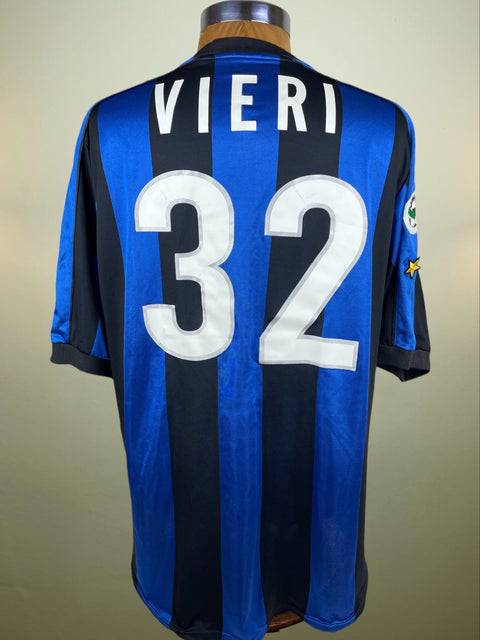 Blue and black striped Inter Milan jersey with 'Vieri' and number '32' on a mannequin against a beige background