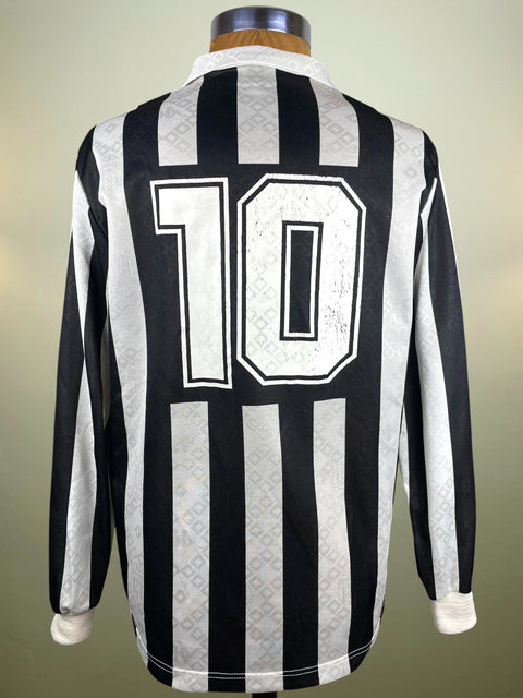 Black and white striped Juventus 1990-91 with number 10 on a mannequin against a neutral background