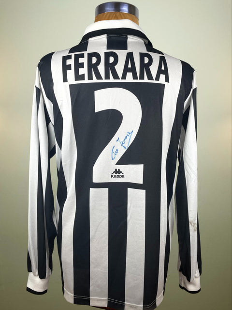 Black and white striped Juve jersey with 'FERRARA' and number '2' on a mannequin against a neutral background.