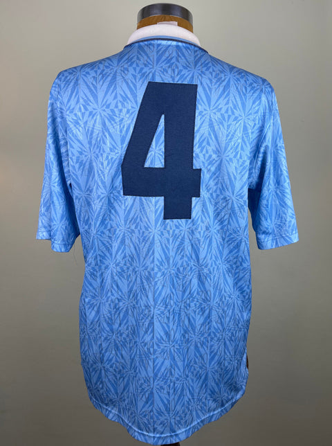 A blue and white striped Lazio 1992-93 home jersey featuring an Umbro logo on the number 4 stitched into the back of the shirt
