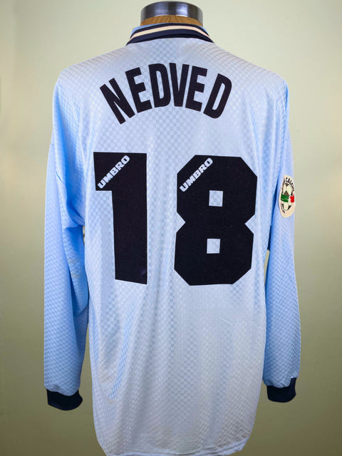 Light blue Lazio 1996 jersey with 'Nedved' and number '18' on a plain background