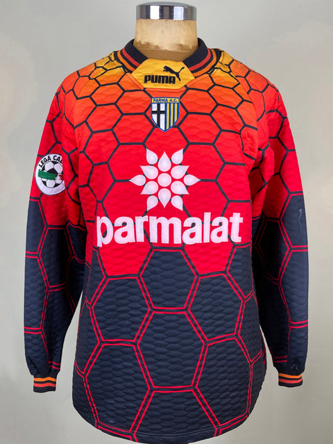 A Puma soccer jersey displayed on a mannequin torso, featuring a red and navy blue hexagonal pattern with the white Parmalat sponsor logo on the chest.