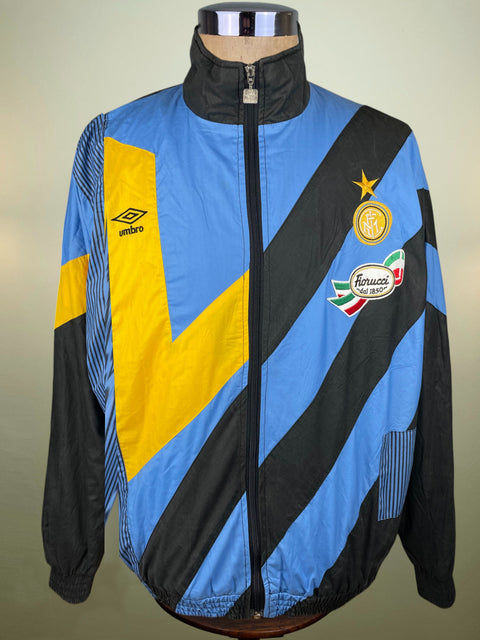 Colorful Umbro Inter Milan jacket with sports branding on a mannequin against a neutral background
