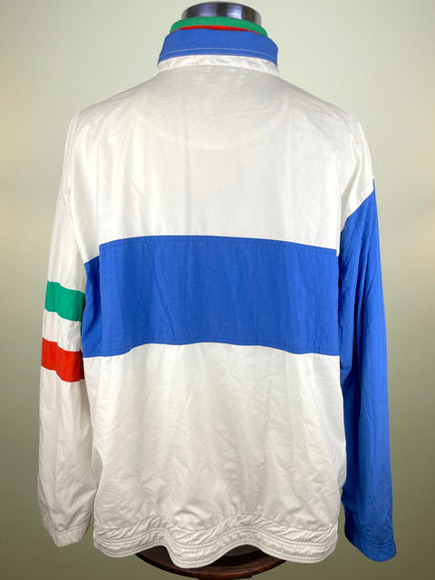 White and blue jacket with Nike logo and various logos on a mannequin against a plain background