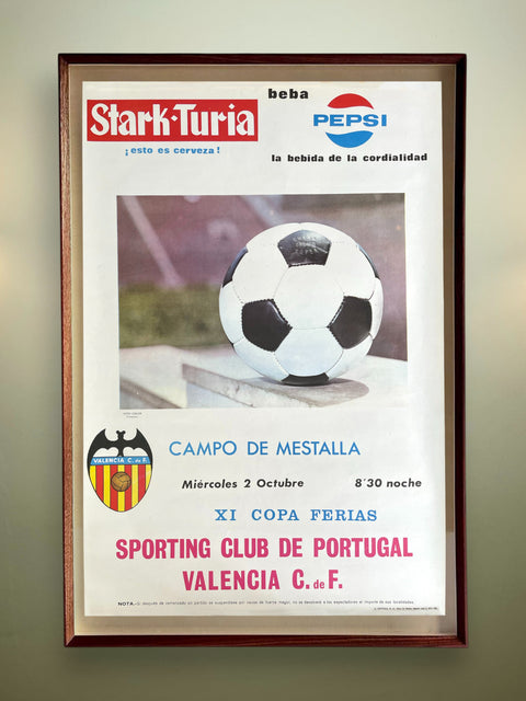Framed poster with a soccer ball, advertising Stark-Turia and Pepsi, on a wall.