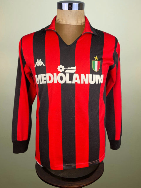 Red and black AC Milan 1988 jersey on a mannequin against a plain background