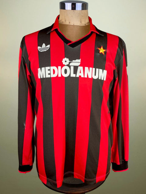 Red and black striped AC Milan 1991/92 jersey with 'Mediolanum' and Adidas logos on a mannequin against a neutral background