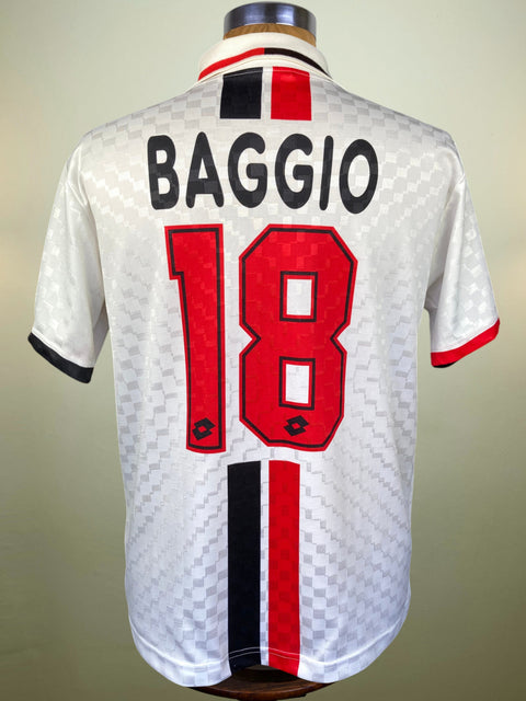 Back view of a white Inter Milan soccer jersey on a mannequin, featuring 'BAGGIO' and the number '18' in red with black outlines, and black, red, and white vertical stripes near the hem.