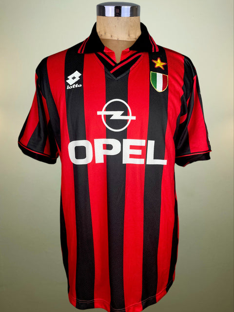 Red and black striped sports jersey with Opel logo on a mannequin against a neutral background