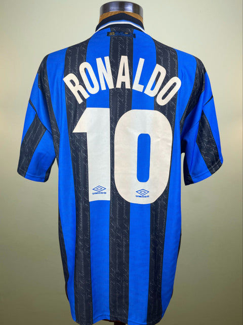Blue and black Inter Milan Umbro 1997-98 jersey with 'RONALDO' and number '10' in white flock on a mannequin against a beige background