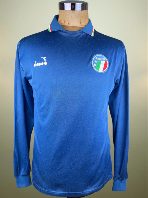 Blue long-sleeve shirt with a logo on a mannequin against a beige background