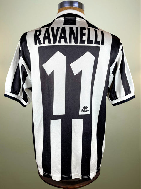 Black and white striped 1996-97 Juve jersey with 'Ravanelli' and number '11' on a mannequin against a beige background