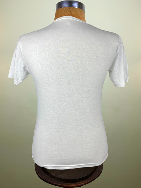 White t-shirt on a mannequin against a beige background
