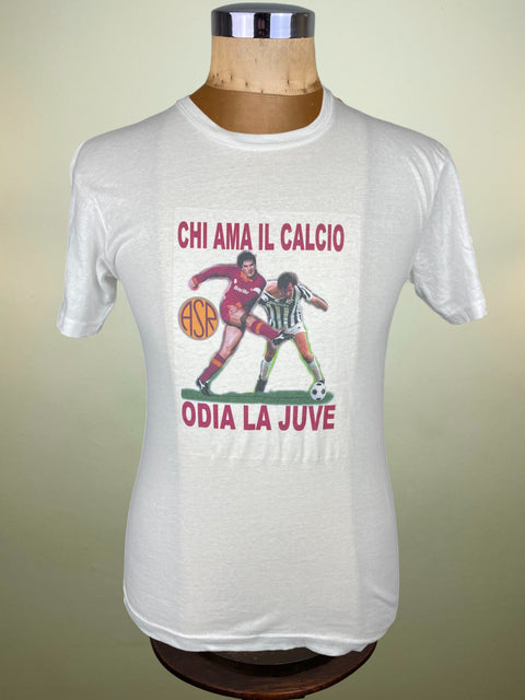 White t-shirt with soccer graphic and text on a mannequin against a beige background