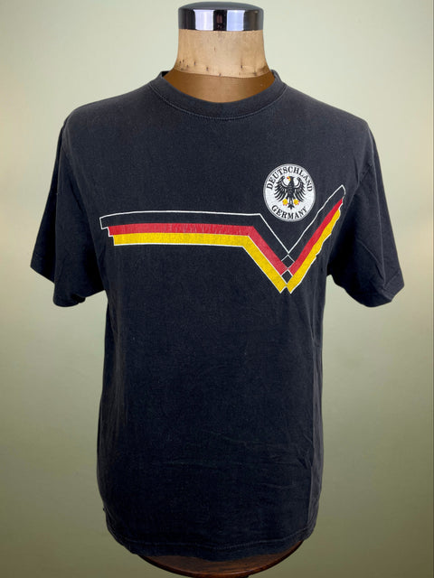 Black t-shirt with German flag design on a mannequin against a beige background