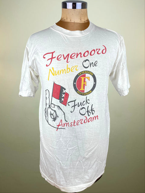 White t-shirt with printed design on a mannequin against a beige background