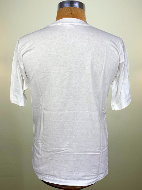 A white short-sleeve crewneck t-shirt displayed on a wooden dress form mannequin, showing the back view against a light beige gradient background.