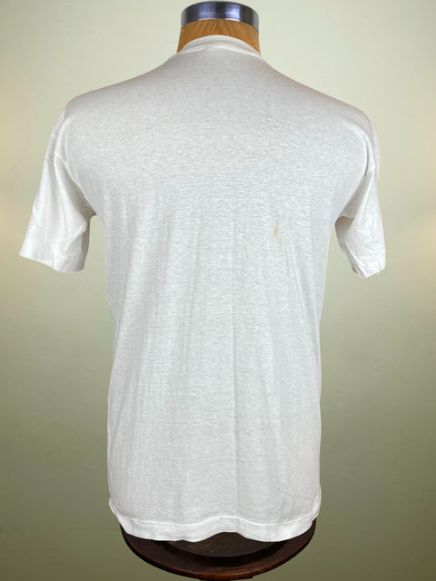 White t-shirt on a mannequin against a beige background