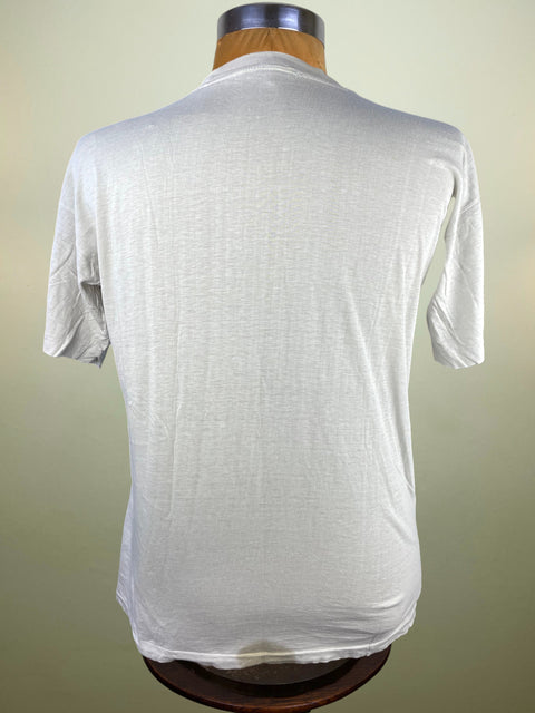 White t-shirt on a mannequin against a plain background