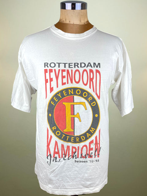 White t-shirt with Feyenoord Rotterdam logo on a mannequin against a beige background