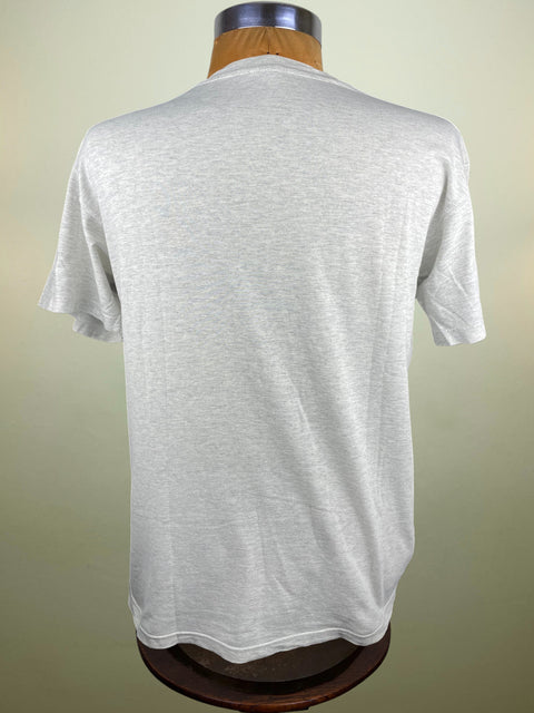 White t-shirt on a mannequin against a beige background