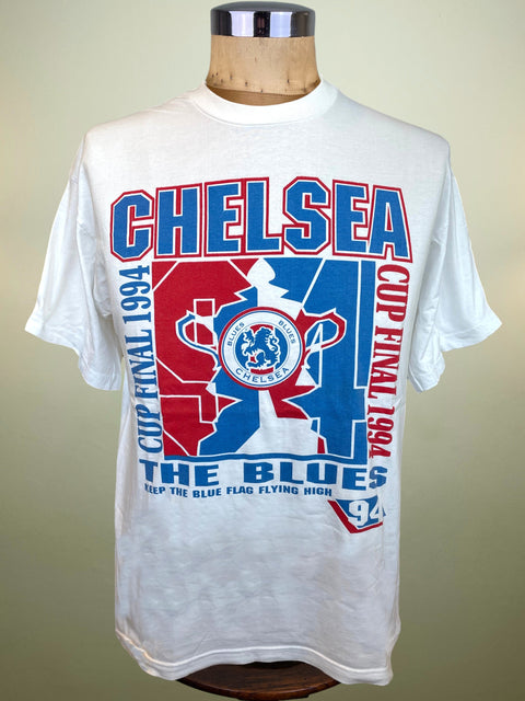 A white short-sleeve Chelsea FC t-shirt displayed on a wooden dress form mannequin. The shirt features a large front graphic celebrating 'CHELSEA CUP FINAL 1994' with red and blue lettering and a central trophy design.