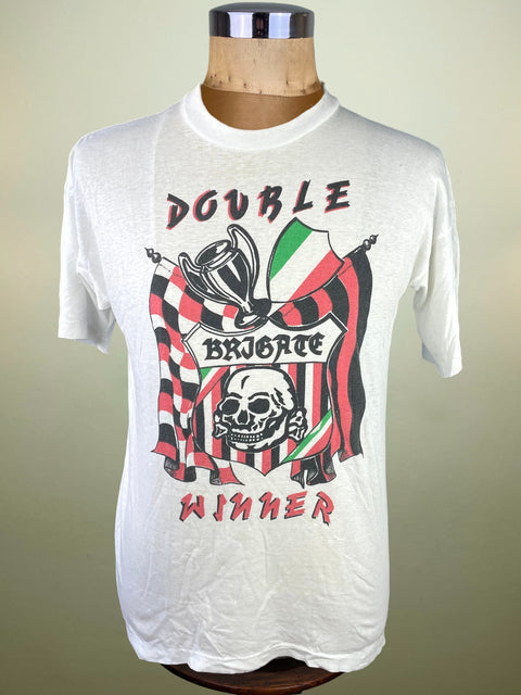 White t-shirt with graphic design on a mannequin against a beige background