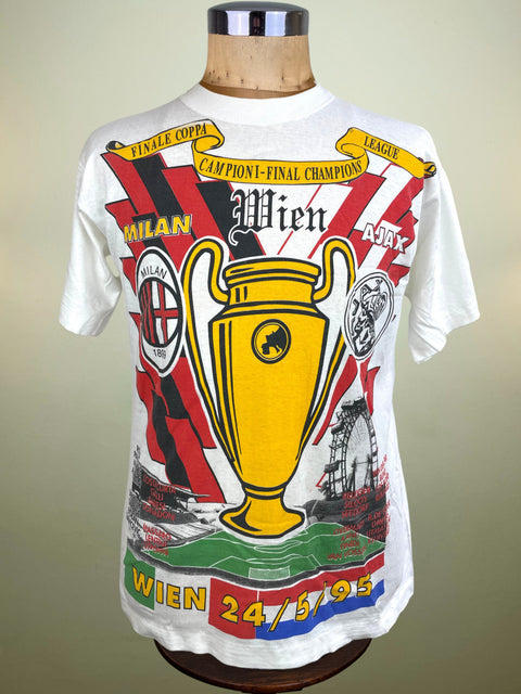 White t-shirt with sports-themed graphics on a mannequin against a gradient background