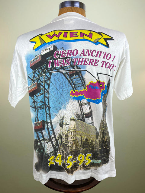 White t-shirt with graphic design and text on a mannequin against a neutral background