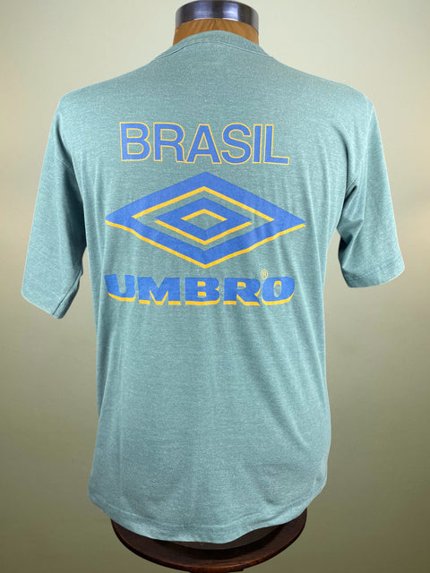 Green t-shirt with 'Brasil' and Umbro logo on a mannequin against a beige background