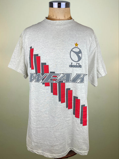 Gray t-shirt with red and black graphics on a mannequin against a beige background