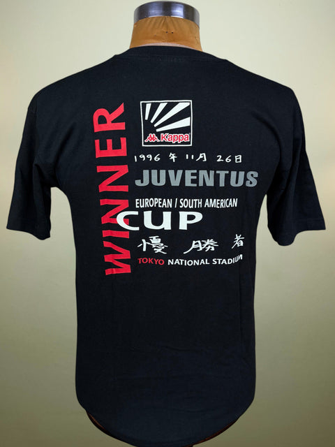 A black short-sleeve T-shirt displayed on a mannequin torso, showing the back side with a large vintage Juventus cup graphic. The graphic features red and white text reading 'WINNER' and 'JUVENTUS EUROPEAN SOUTH AMERICAN CUP', along with the Kappa logo and event details from Tokyo National Stadium.